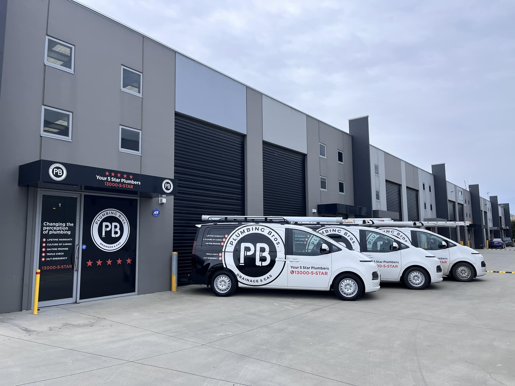 Photo of Plumbing bros Melbourne office with vehicles parked in front.